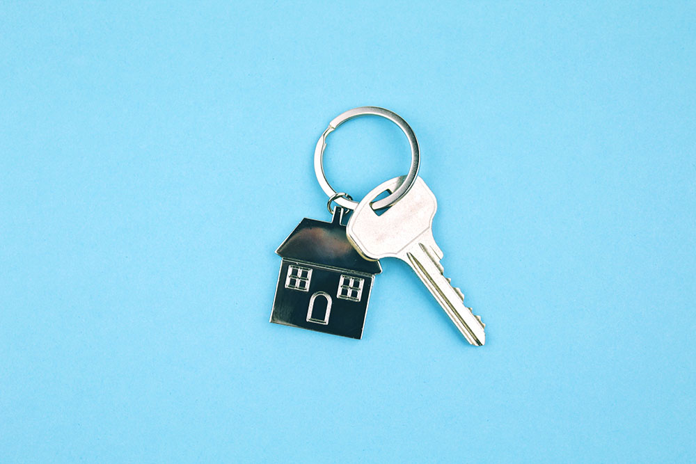 key-with-house-keychain-on-a-blue-background-home-2021-09-03-02-37-55-utc